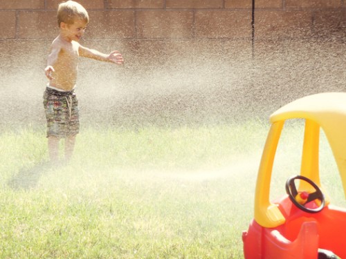 playing in sprinklers