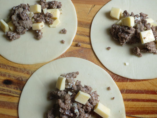 beef-and-cheese-empanads-laid-on-cutting-board