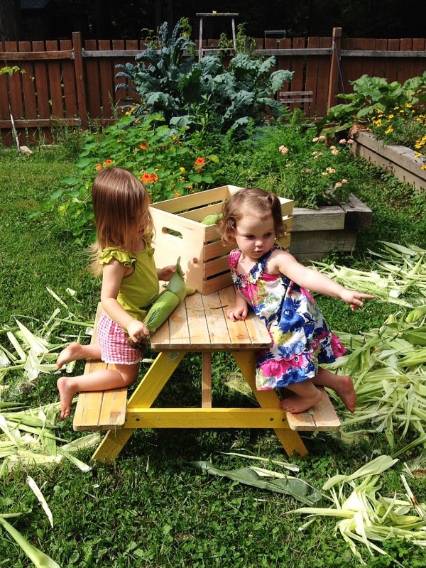 girls shucking corn