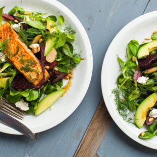 Warm salmon and spinach salad with roasted beets, avocado, feta and olives